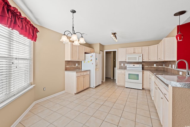 kitchen with decorative backsplash, white appliances, sink, pendant lighting, and an inviting chandelier