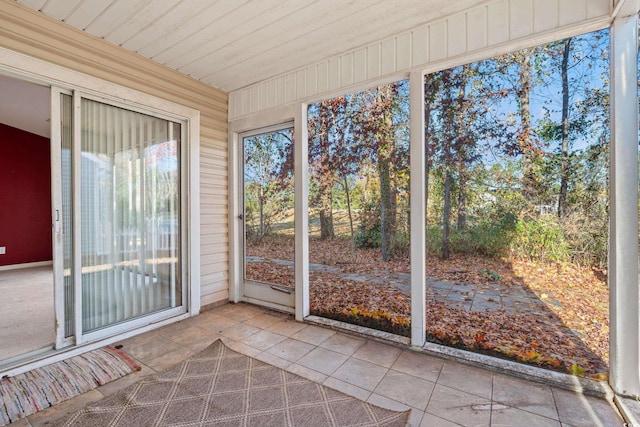 unfurnished sunroom featuring wooden ceiling