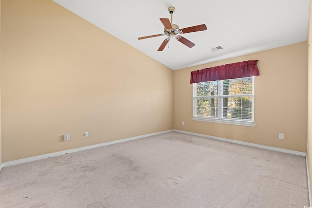 spare room with light carpet, vaulted ceiling, and ceiling fan