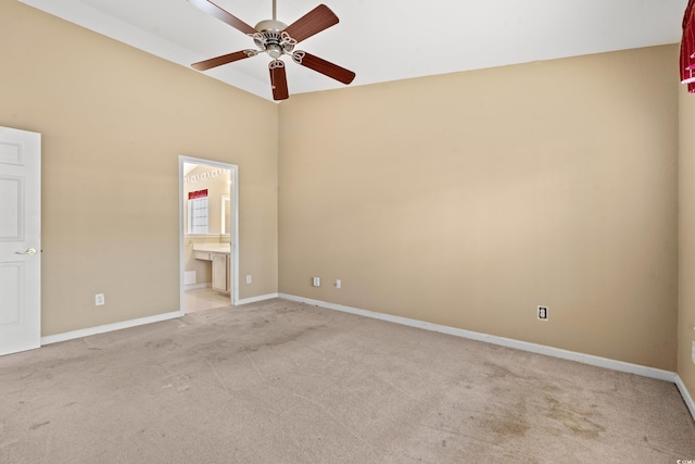 carpeted spare room featuring ceiling fan