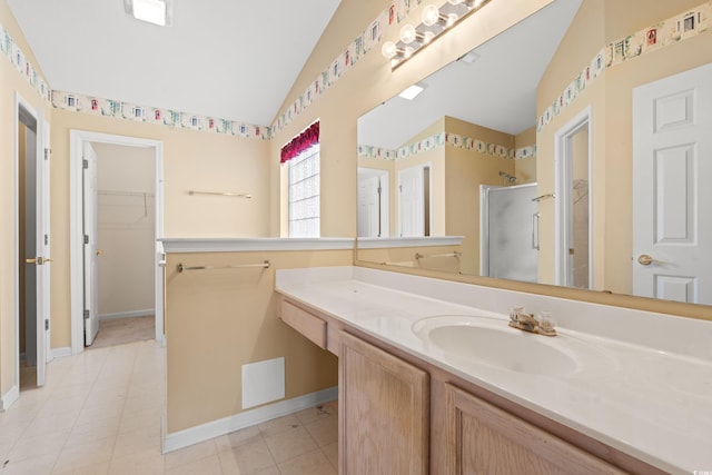 352 Mckendree Ln, Myrtle Beach, SC 29579 - bathroom with vaulted ceiling, a shower stall, a spacious closet, vanity, and baseboards