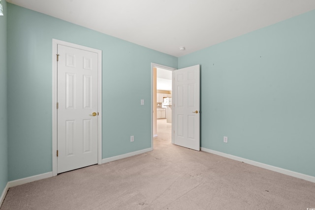 unfurnished bedroom featuring light carpet