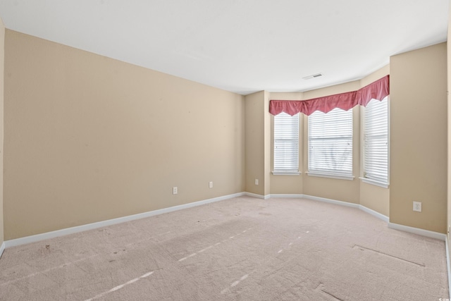 empty room featuring light colored carpet