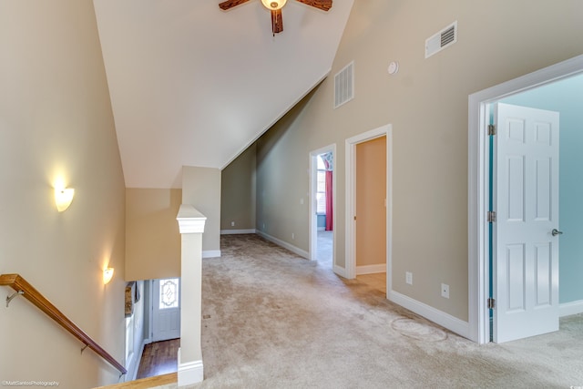 unfurnished living room with ceiling fan, lofted ceiling, and light carpet