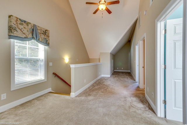 additional living space featuring light carpet, ceiling fan, and lofted ceiling