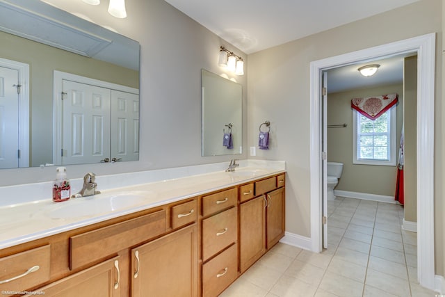 bathroom featuring tile patterned flooring, vanity, and toilet