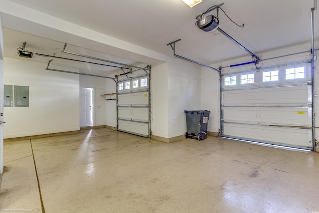 garage with electric panel and a garage door opener