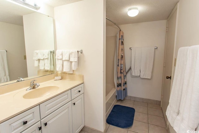 bathroom featuring tile patterned floors, vanity, shower / bath combination with curtain, and a textured ceiling