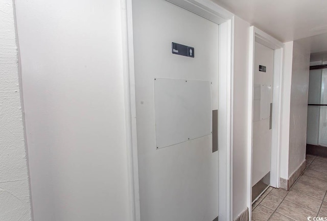 hallway with light tile patterned flooring