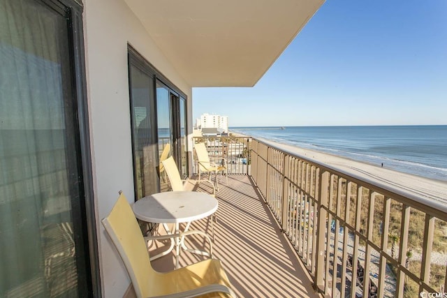 balcony with a view of the beach and a water view