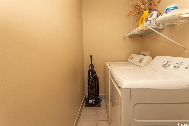 laundry room featuring washing machine and dryer and light tile patterned floors