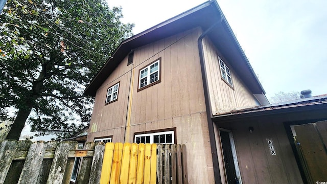 view of property exterior featuring fence