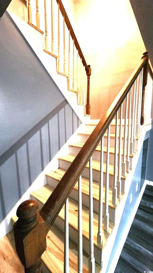 stairway with wood finished floors