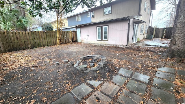 rear view of house featuring a fenced backyard