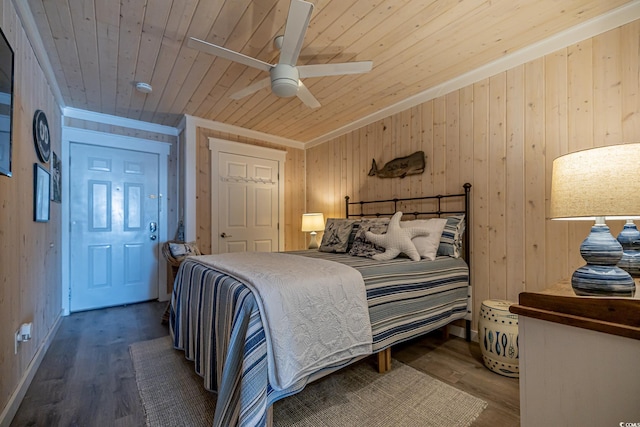 bedroom featuring hardwood / wood-style flooring, ceiling fan, wood ceiling, and wooden walls