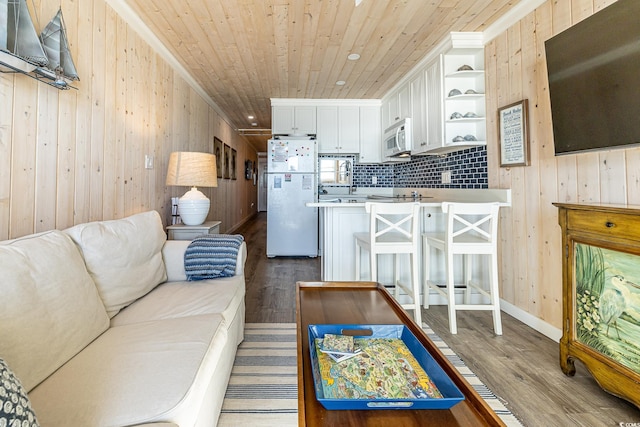 living room featuring wood walls and wood-type flooring