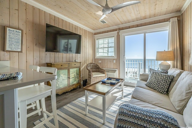 living room with wood walls, hardwood / wood-style floors, and wooden ceiling