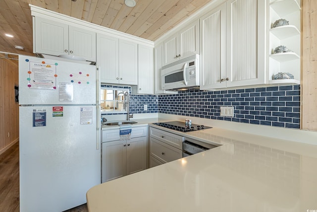 kitchen featuring white cabinetry, sink, wooden ceiling, white appliances, and hardwood / wood-style flooring