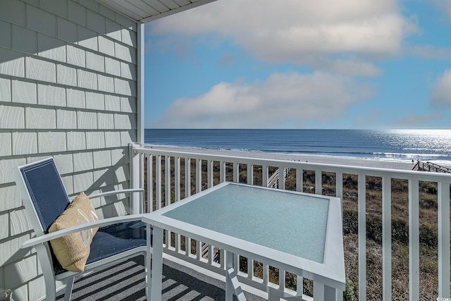 balcony with a view of the beach and a water view