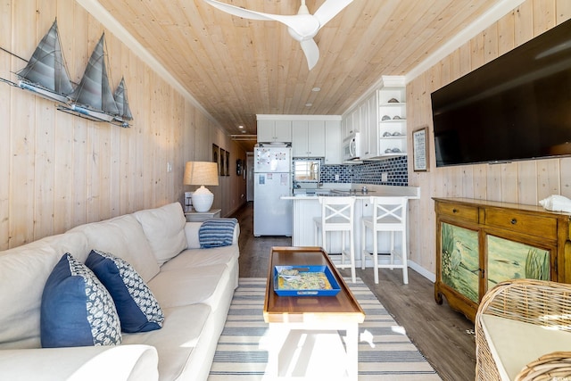 living room featuring wooden walls, ceiling fan, dark wood-type flooring, and wood ceiling