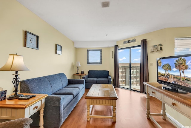 living room with light hardwood / wood-style flooring and a healthy amount of sunlight