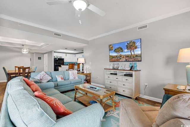 living room featuring crown molding and hardwood / wood-style flooring