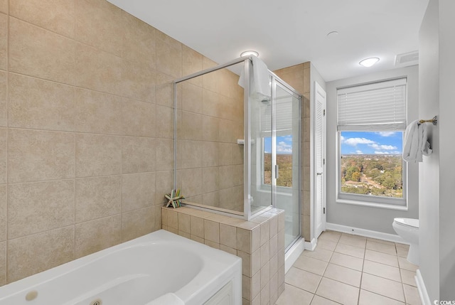 bathroom featuring tile patterned flooring, toilet, and shower with separate bathtub