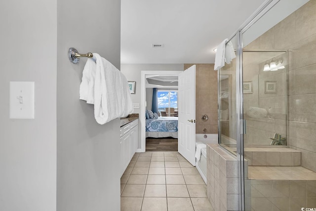 bathroom featuring tile patterned flooring and plus walk in shower