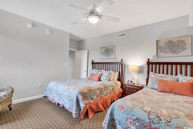 bedroom with carpet flooring, ceiling fan, and a textured ceiling