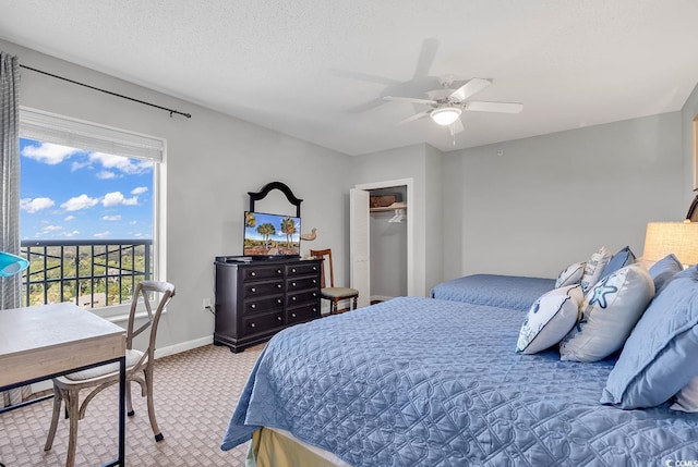 carpeted bedroom featuring ceiling fan, a closet, and a textured ceiling