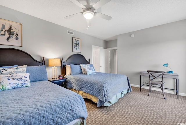 bedroom with carpet flooring, ceiling fan, and a textured ceiling