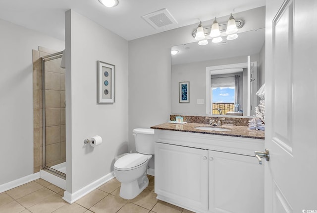 bathroom featuring tile patterned flooring, toilet, and a shower with door