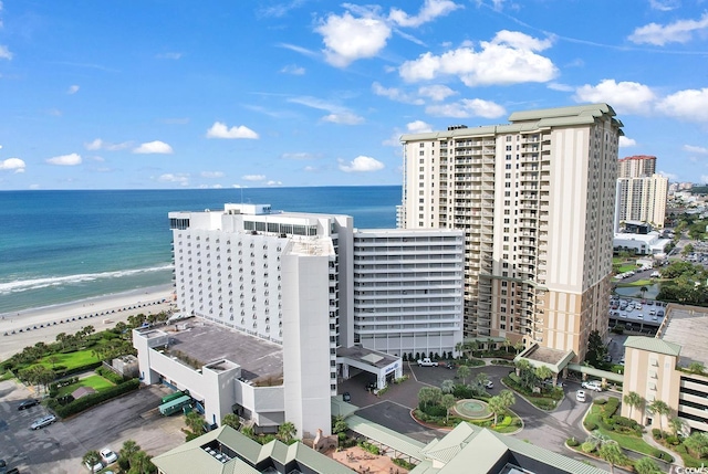 aerial view with a water view and a beach view