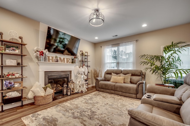 5433 Merrywind Ct, Myrtle Beach, SC 29579 - living area featuring wood finished floors, a glass covered fireplace, and recessed lighting