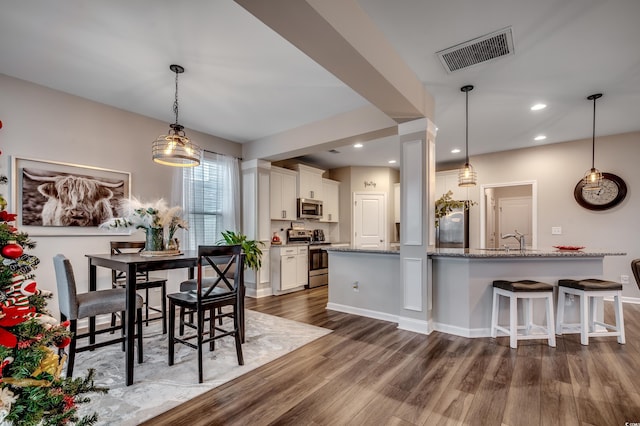 dining space featuring dark hardwood / wood-style flooring and sink