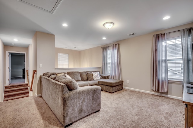 carpeted living room with a healthy amount of sunlight