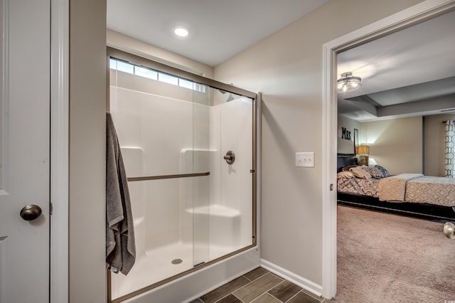 bathroom with hardwood / wood-style floors and a shower with door