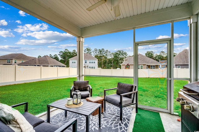 sunroom / solarium featuring ceiling fan and wooden ceiling