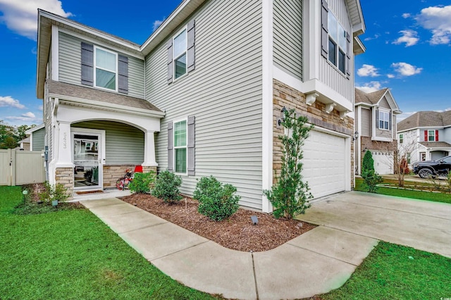 5433 Merrywind Ct, Myrtle Beach, SC 29579 - view of front facade with a garage, stone siding, concrete driveway, and covered porch