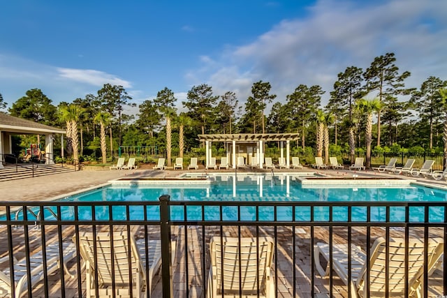 5433 Merrywind Ct, Myrtle Beach, SC 29579 - community pool featuring a pergola, view of scattered trees, and a patio area