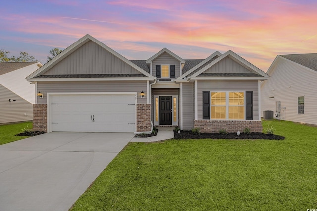 craftsman inspired home featuring a lawn, cooling unit, and a garage