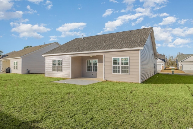 rear view of property with a yard and a patio