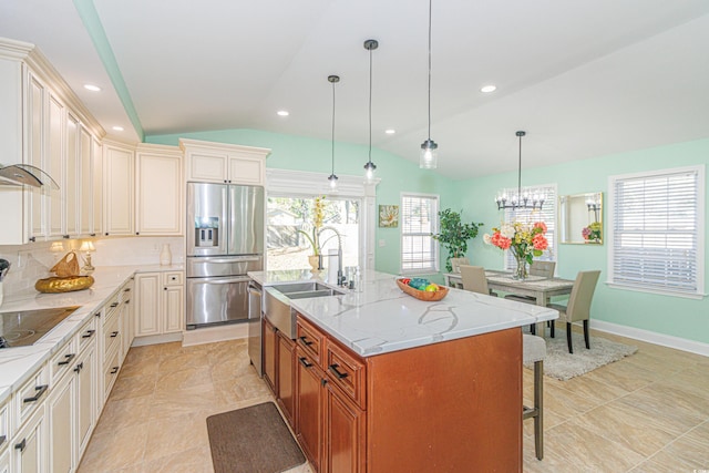 kitchen featuring stainless steel appliances, a kitchen island with sink, sink, pendant lighting, and lofted ceiling