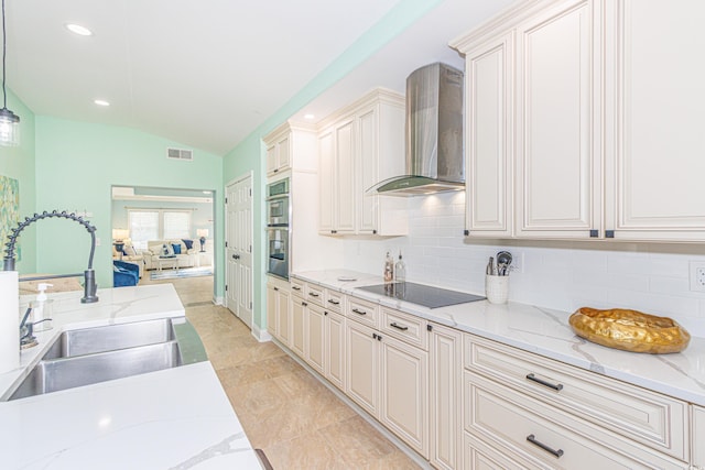 kitchen with sink, wall chimney range hood, lofted ceiling, decorative light fixtures, and black electric stovetop