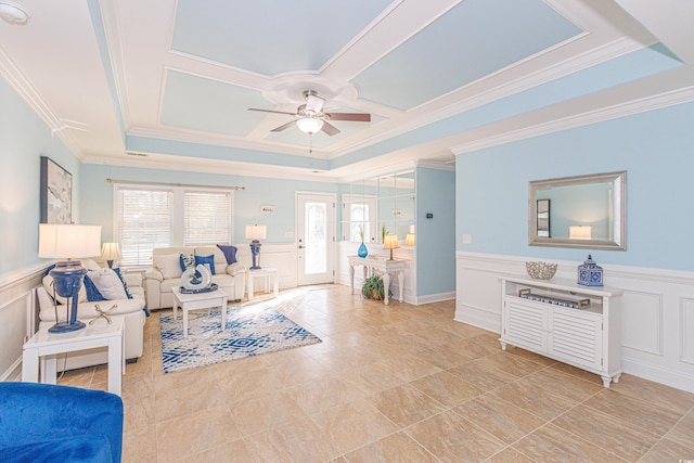 living room featuring ornamental molding and a tray ceiling