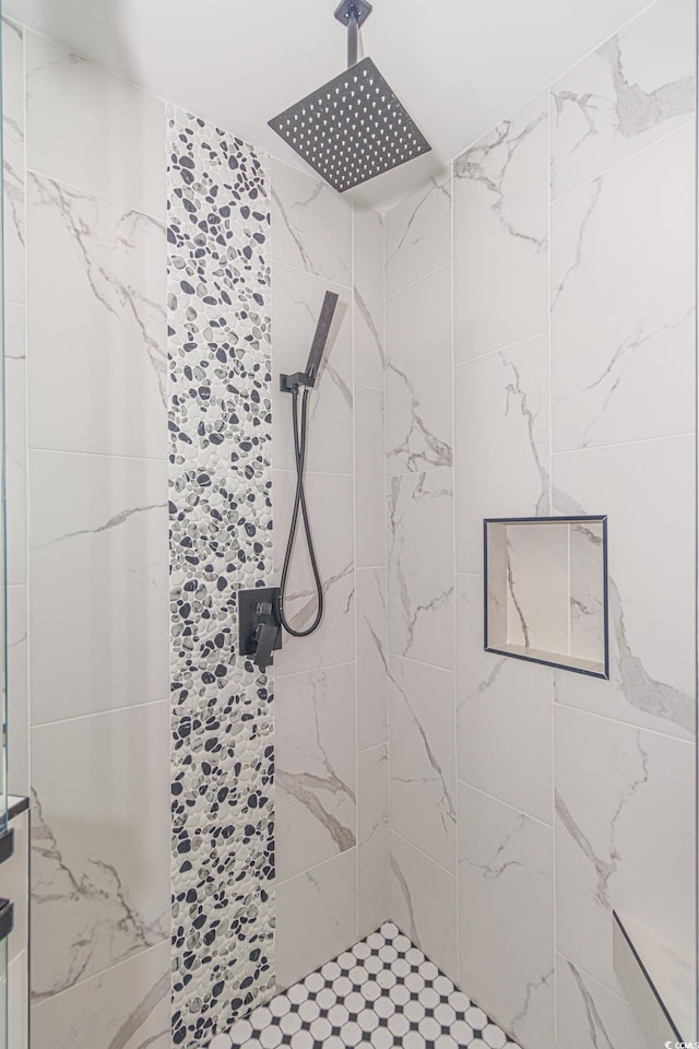 bathroom with a tile shower