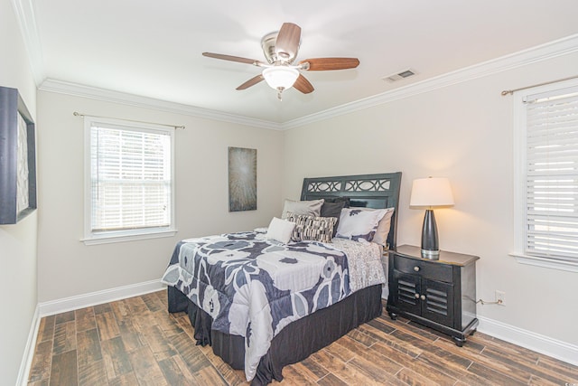 bedroom featuring dark hardwood / wood-style floors, ceiling fan, and crown molding