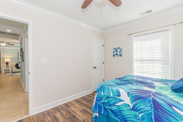 bedroom with hardwood / wood-style flooring, ceiling fan, and crown molding