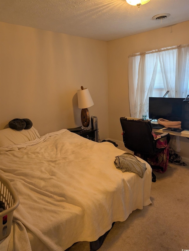 carpeted bedroom featuring a textured ceiling