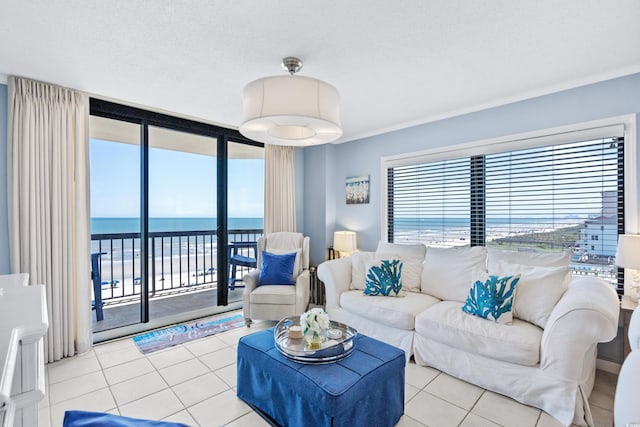 tiled living room with a textured ceiling and a water view